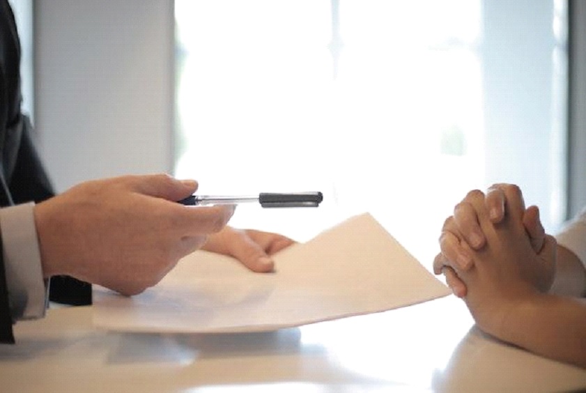 A pen handing over to another person